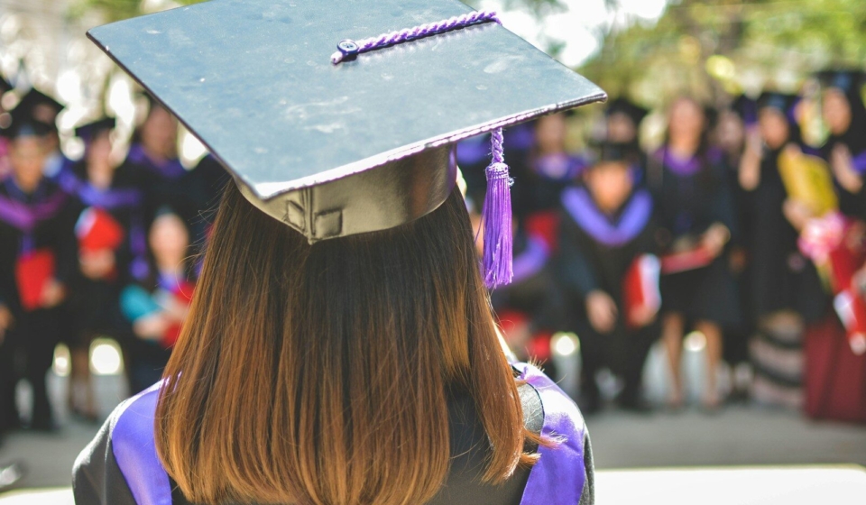 woman wearing academic cap and dress selective focus photography
