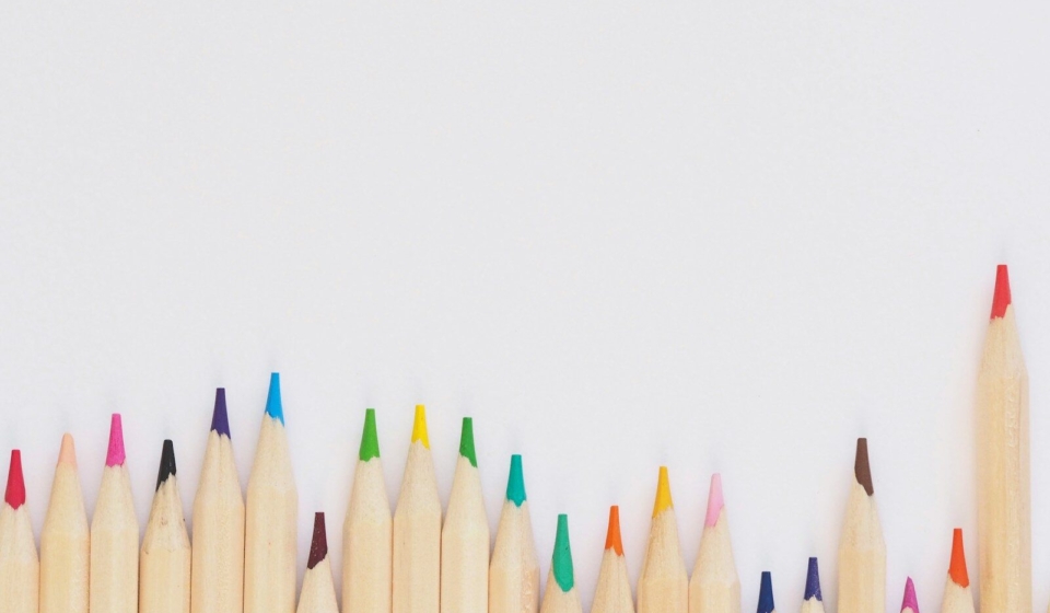 colored pencil lined up on top of white surface
